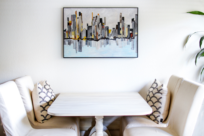 white breakfast table and slipcovered chairs