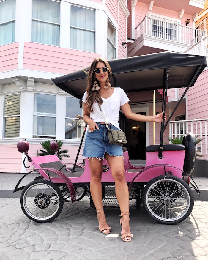 pink golf cart in front of pink hotel