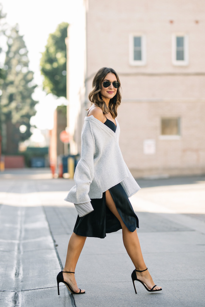 layering a sweater over a slip dress